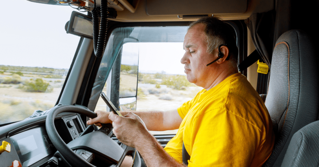 Truck driver using phone while driving, distracted.