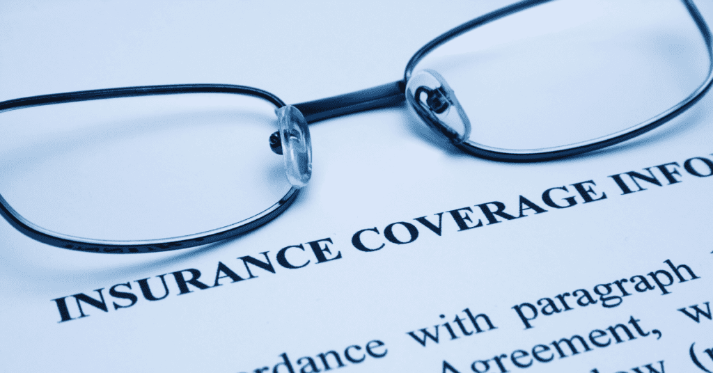 Glasses resting on a document titled "Insurance Coverage Information," representing MedPay insurance in Kansas and Missouri