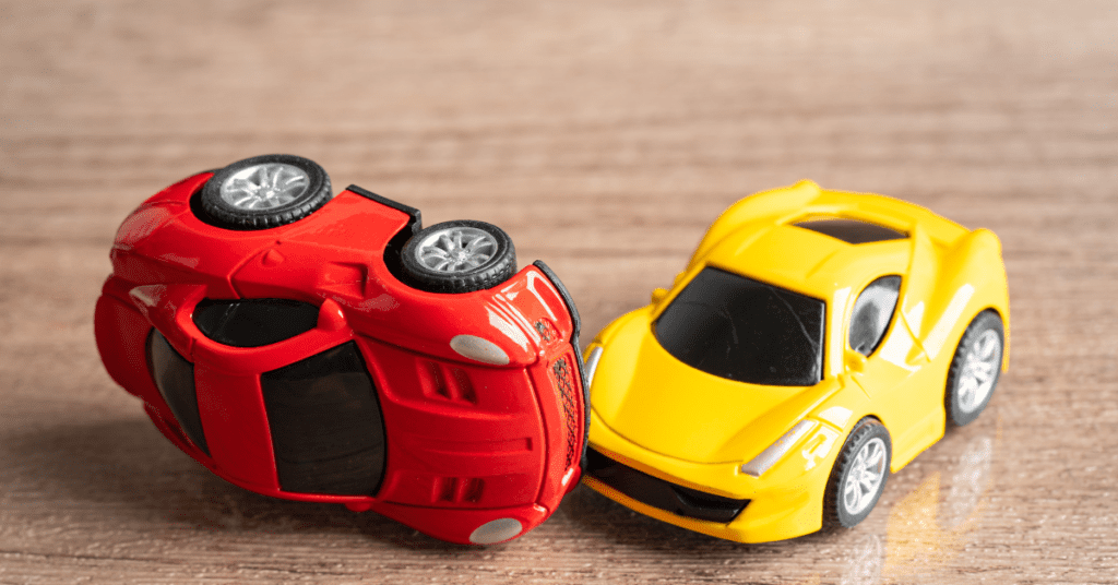 Toy cars involved in a simulated crash, symbolizing personal injury protection (PIP) coverage in car accidents