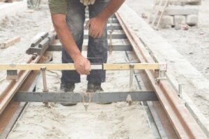 Worker adjusting rail tracks as part of construction projec