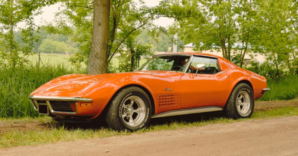 Red classic Chevrolet Corvette parked near trees, representing a collector vehicle that could be involved in a Kansas City auto accident property damage claim.