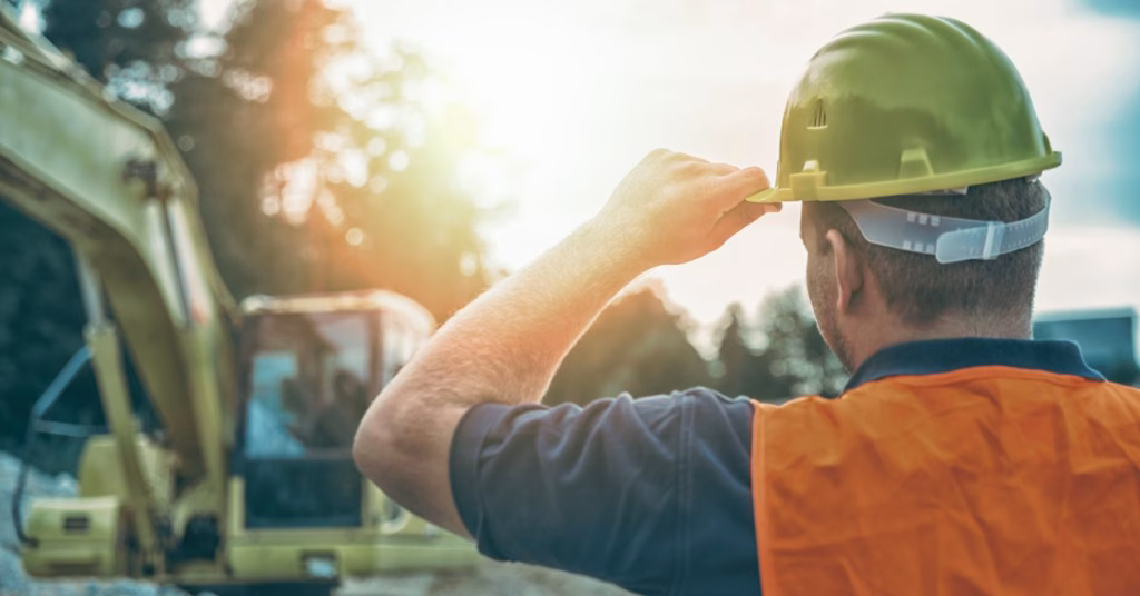 Construction worker wearing a hard hat and safety vest at a job site in Kansas City, representing potential third-party liability in workplace injury claims.