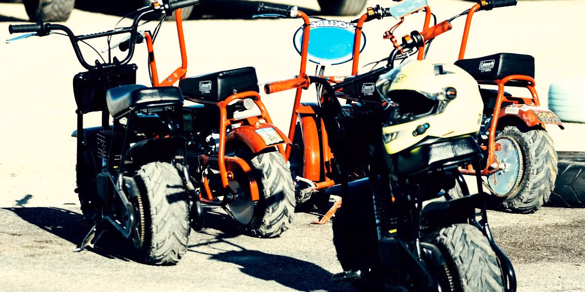 Unlicensed Minibikes Parked on Pavement – Summer Safety and Legal Risks in Kansas City (1) Multiple minibikes and a helmet on pavement, highlighting safety and legal concerns for off-road vehicles in Kansas City.